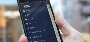 クラウドPBXのスマートフォンを手に持っている